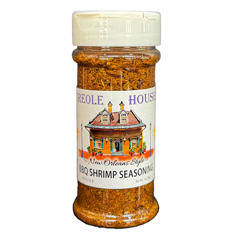 A bottle of Creole House New Orleans Style BBQ Shrimp Seasoning with a white cap and a white label featuring a colorful house illustration, set against a plain white background.